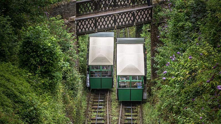 The twin carts of Lynmouth and Lynton's cliff railway in Devon surrounded by foliage clad slopes