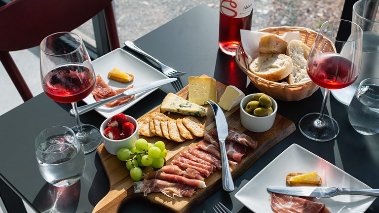 A charcuterie spread and glasses of wine at Alder Vineyard