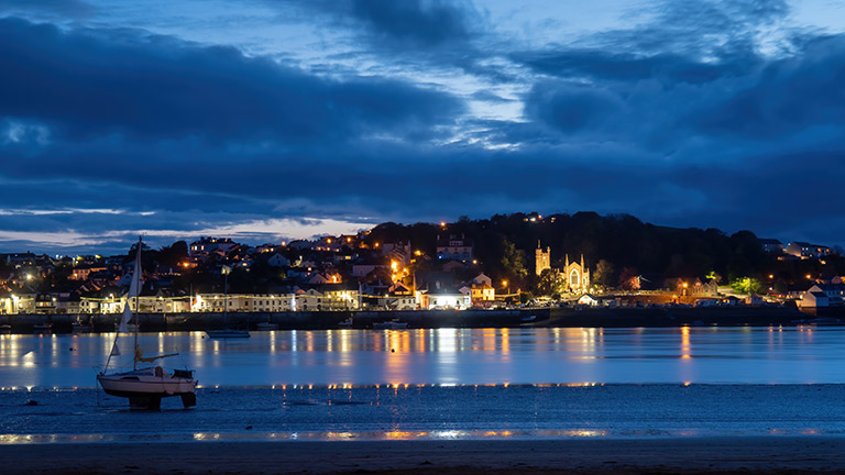 A view of Appledore at night-time from Instow with the lights of the village twinkling in the water of the estuary