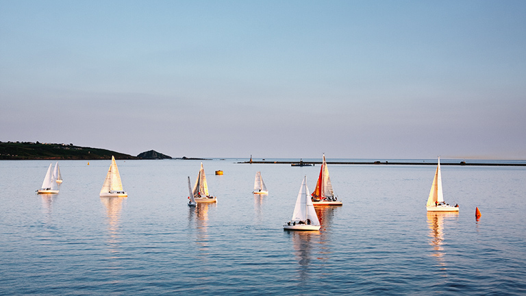 Sailing boats atop the glassy waters of Plymouth Sound