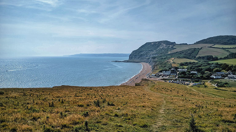 A distant view of Seatown from the surrounding cliffs in Dorset