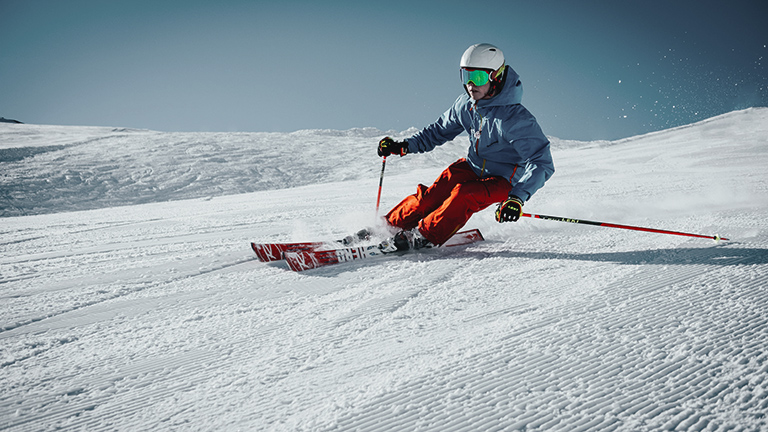 A person skiing down a powdery slope