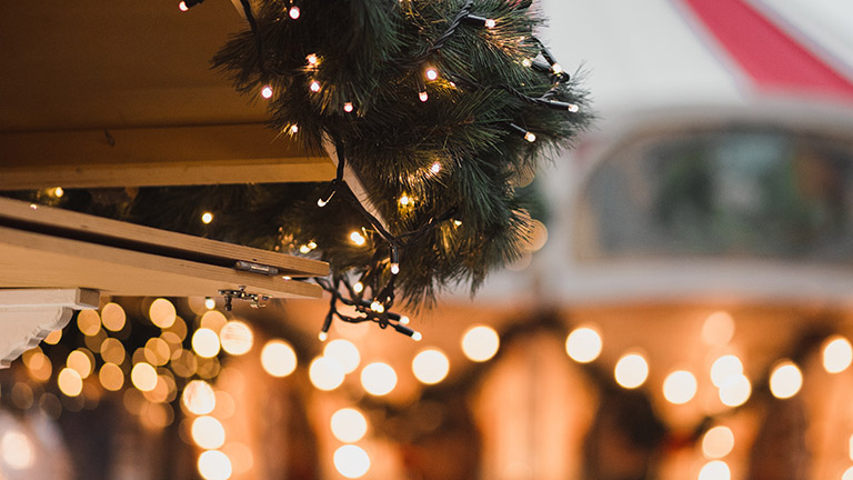 Christmas decorations with fairy lights and pine needles at a festive Christmas market