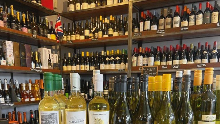 Shelves lined with bottles of wine at Teddington Stores, Cotswolds