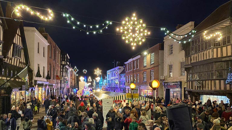 Christmas lights, Tudor buildings, Christmas markets and shoppers at Tewkesbury Christmas Festival