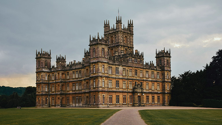 A view of the grand Highclere Castle as daylight fades