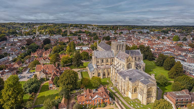 An aerial view of Winchester Cathedral hugged by the city
