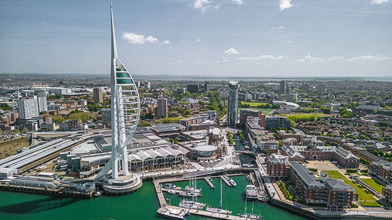 An aerial view of the Spinnaker Tower, harbour and city of Portsmouth in Hampshire