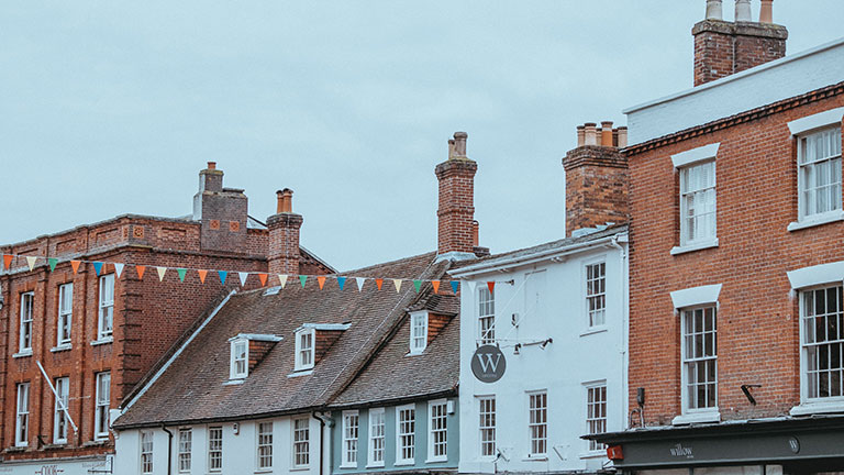 Bunting-lined buildings along Lymington high street in the New Forest, Hampshire