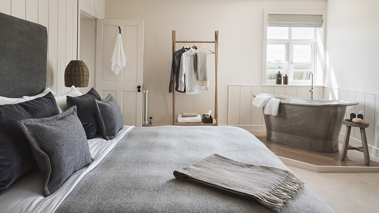 One of Brick House Farm's beautiful bedrooms with a freestanding bath | Boutique Retreats