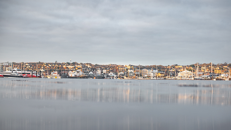 The mirror-like water of Cowes Beach overlooking the town