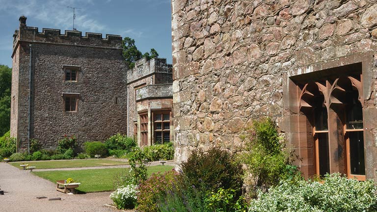 The stone walls and manicured pathways of Muncaster Castle in the Lake District