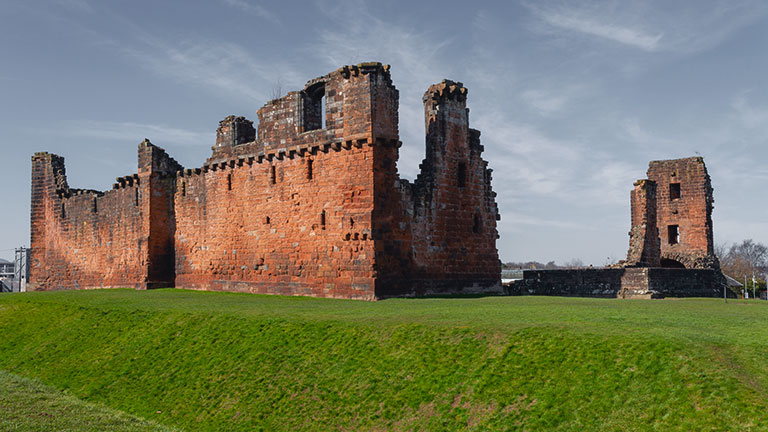 The striking remains of Penrith Castle under blue skies