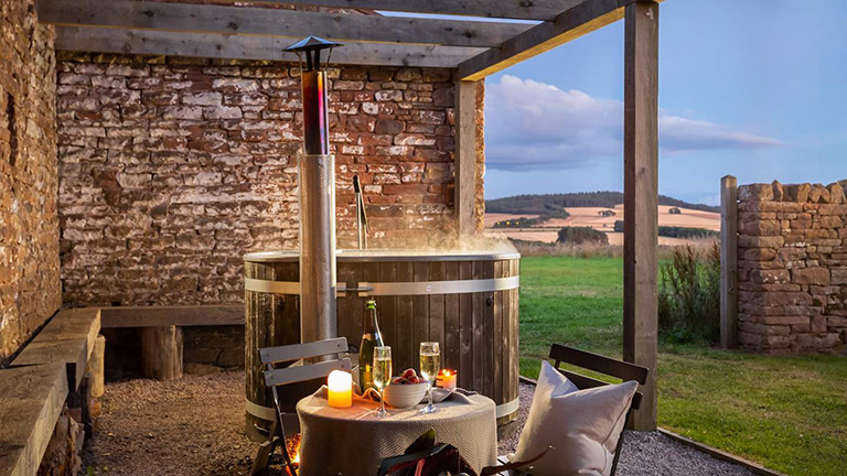 The outdoor hot tub and lakeland views of Luna in Penrith