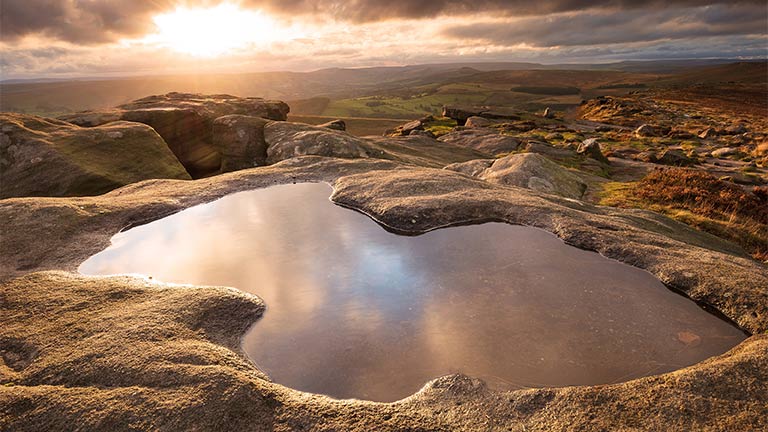Looking down at the beautiful water at Stanage Edge in the Peak District