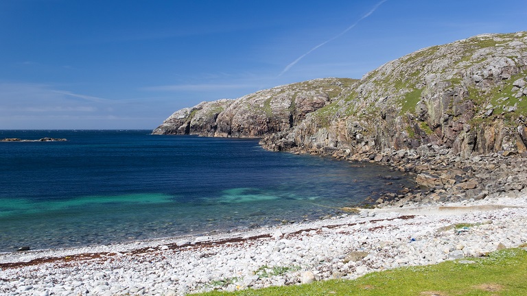 A picturesque white sand beach with turquoise waters along the Hebridean Way 