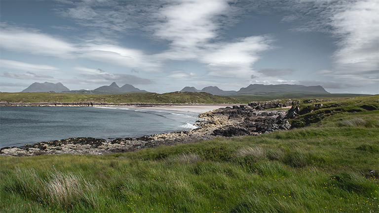 The beautiful Achnahaird Beach overlooked by distant mountains