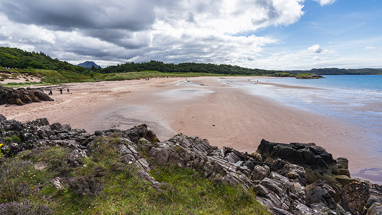 Views overlooking Gairloch Beach, backed by trees and mountains