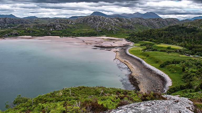 A dramatic view overlooking Gruinard Beach between mountain and sea