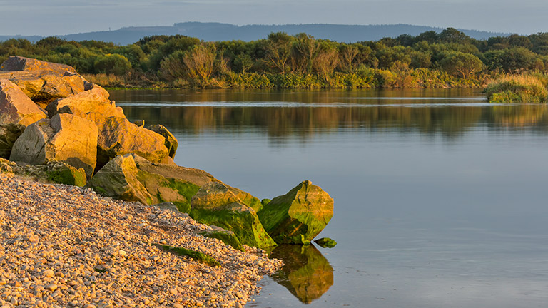 Calm water reflecting tranquil scenery at Spey Bay