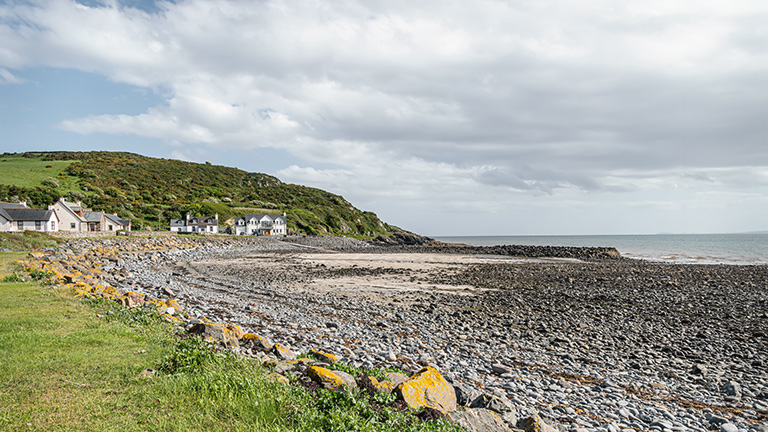 The pebble-strewn shores of Stairhaven Beach