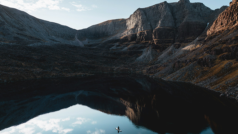 A paddleboarder on Loch Maree below Beinn Eighe