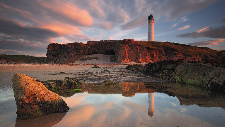 A view of Covesea Lighthouse at sunset