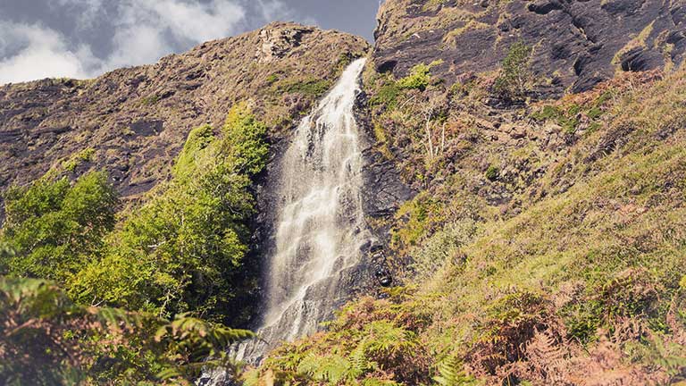 A tumbling waterfall along the walking route to Boreraig in Skye