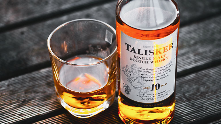 A bottle and poured glass of classic Talisker single malt whisky in Skye