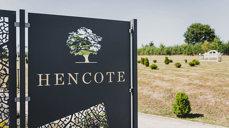 The attractive gates of Hencote Vineyard in Shropshire with manicured lawns in the background