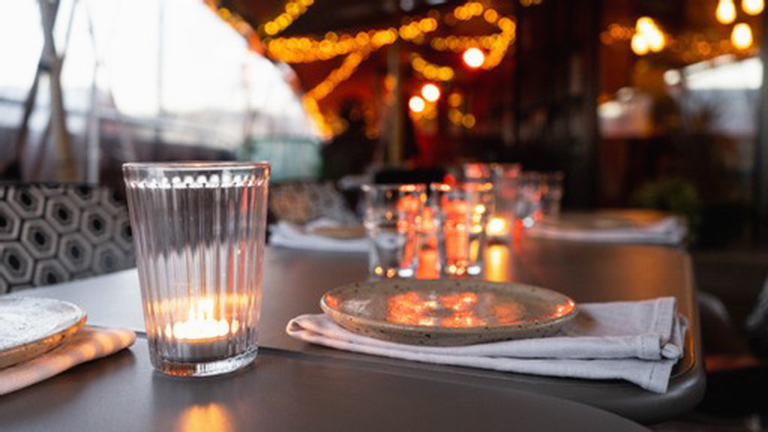 A table illuminated by fairylights at Box-E, Bristol