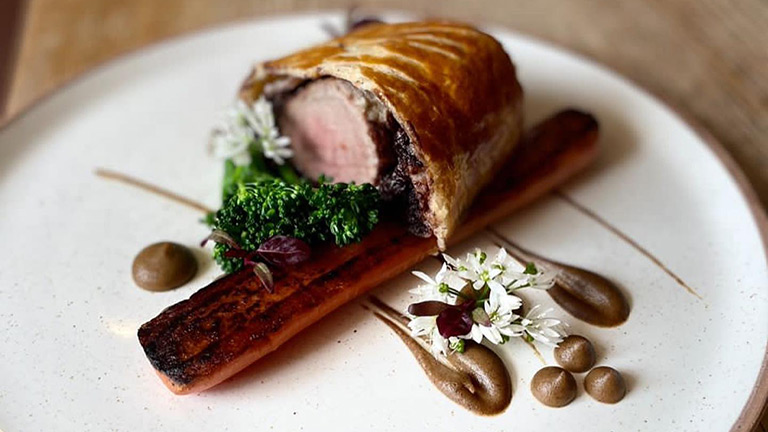 A home-made beef wellington served atop a decorative plate of food at the Hood Arms in Kilve