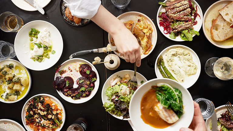 A table filled with plates of artisan dishes at Root, Wells