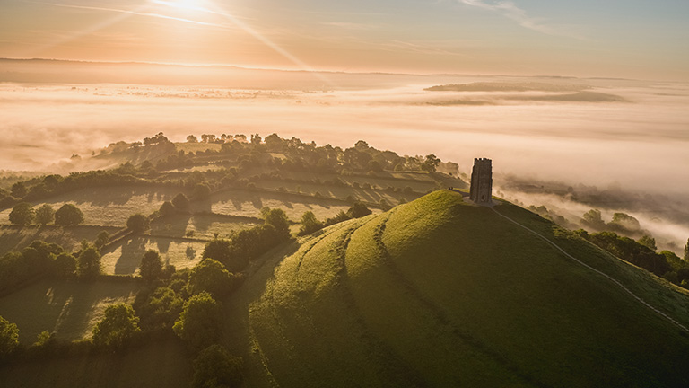 Glastonbury Tor at sunset with low clouds