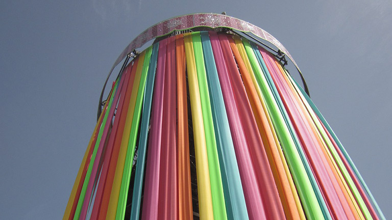 Looking up at the colourful Ribbon Tower at Glastonbury Festival