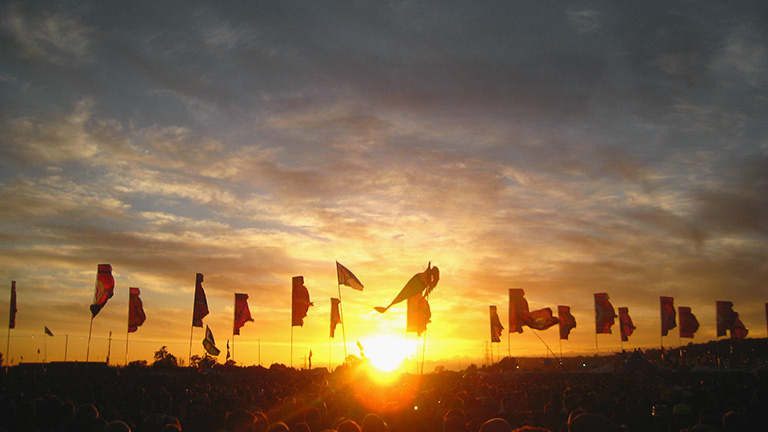 A beautiful Glastonbury sunset over festival flags 