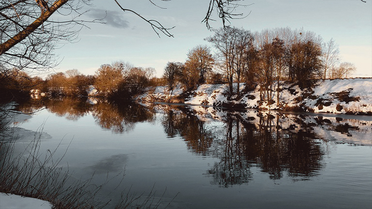 Snow dusted lake in the Wye Valley