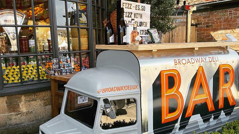 A miniature vintage van used as a display outside of Broadway Deli in Worcestershire