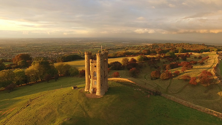 A bird's eye view of Broadway Tower at golden hour during a favourite pub walk in the Cotswolds
