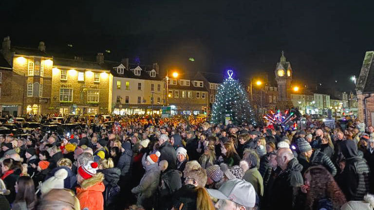 Crowds enjoying the Christmas lights switch on and entertainment at Thirsk Christmas Market